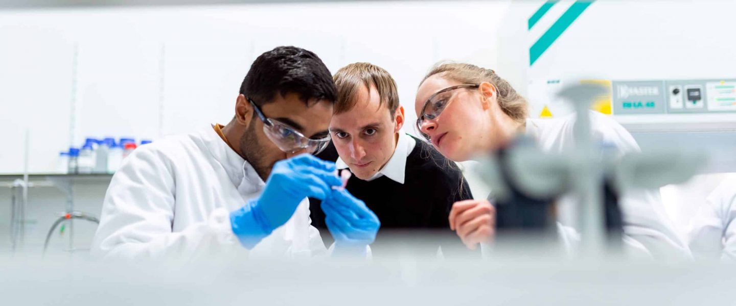 Picture of three scientists examining results; learn what can cause a false positive drug test for thc